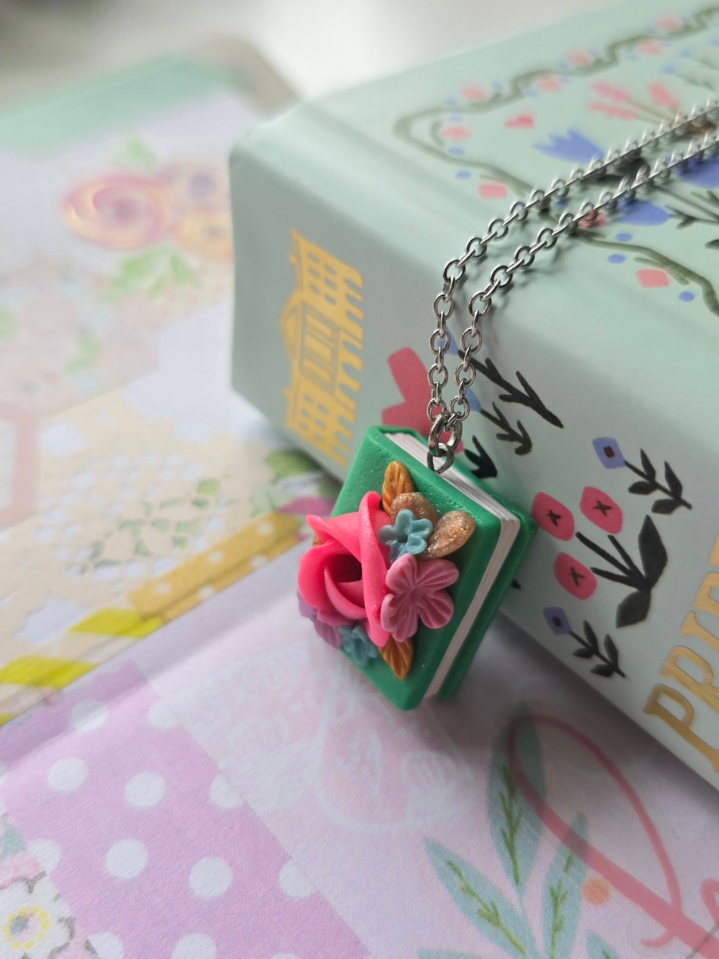 Polymer Clay Book necklace handmade in the Philippines by Angeli Del Rosario with Pride and Prejudice in the background