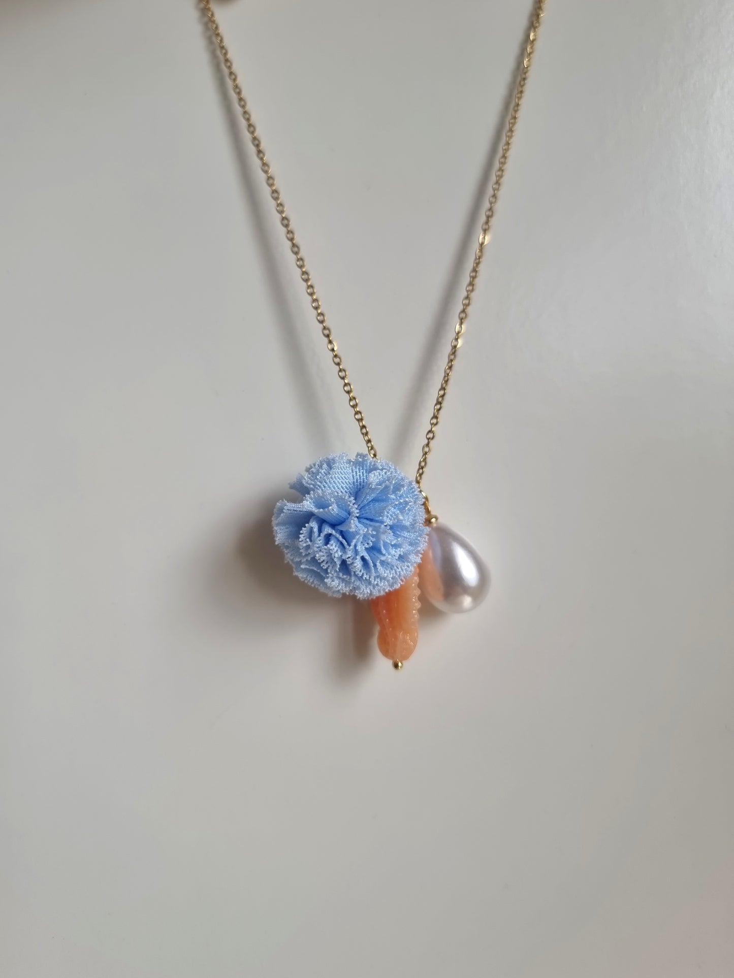 Meri! Seahorse charm necklace in peach with blue pompom